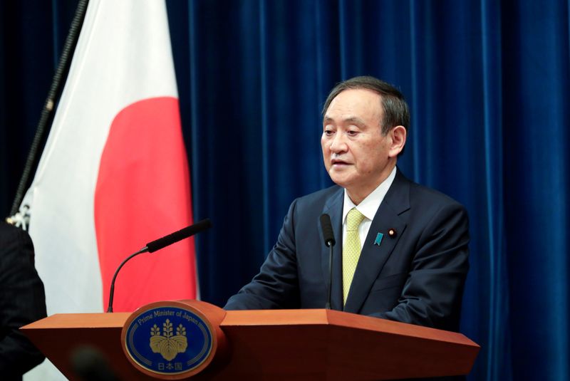 FILE PHOTO: Japanese Prime Minister Yoshihide Suga speaks during a
