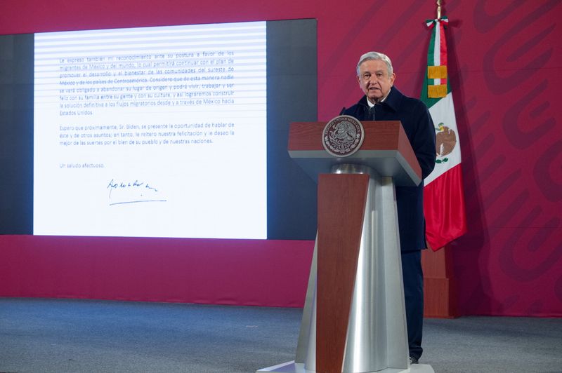 Mexico’s President Andres Manuel Lopez Obrador speaks as a screen
