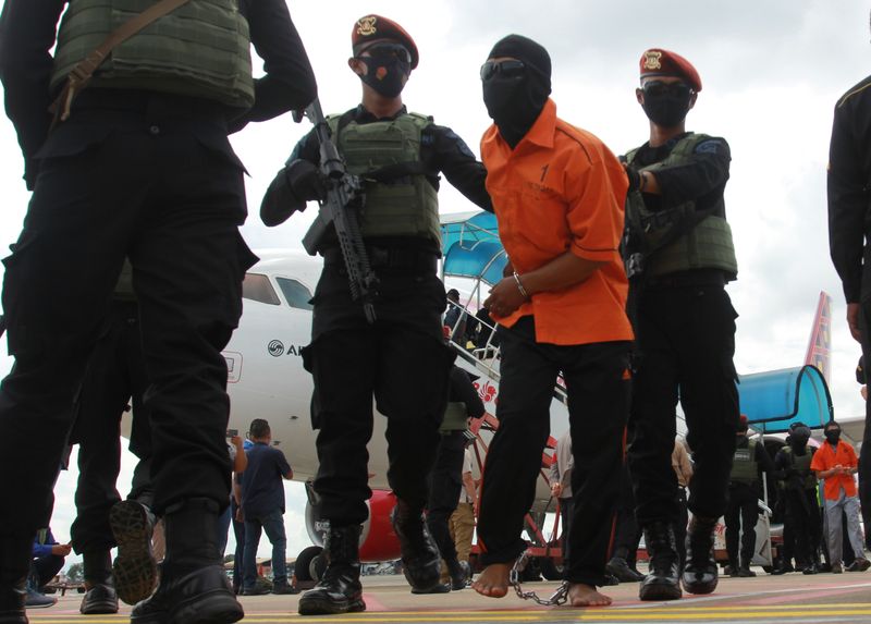 Densus 88 escort a terror suspect at Soekarno-Hatta International Airport