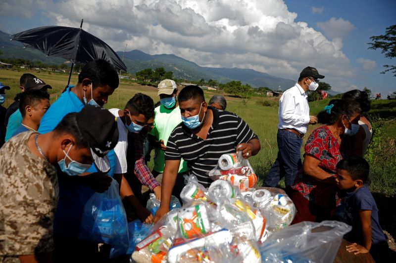 Residents of the Colonia Libertad receive goods from a political
