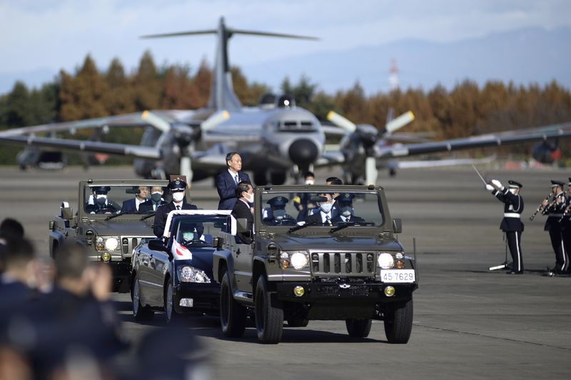 FILE PHOTO: Japanese Prime Minister Yoshihide Suga reviews Japan’s Air