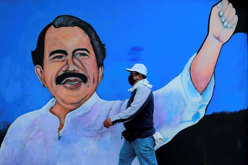 FILE PHOTO: A man walks by a mural depicting Nicaraguan
