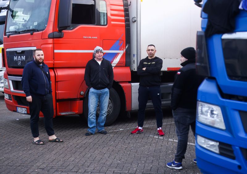 Lorry drivers from Poland speak with each other at Ashford
