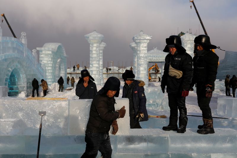 The Wider Image: China’s ice sculptors build frozen castles in