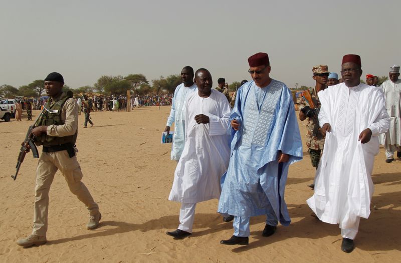 FILE PHOTO: Bazoum walks with members of his delegation at