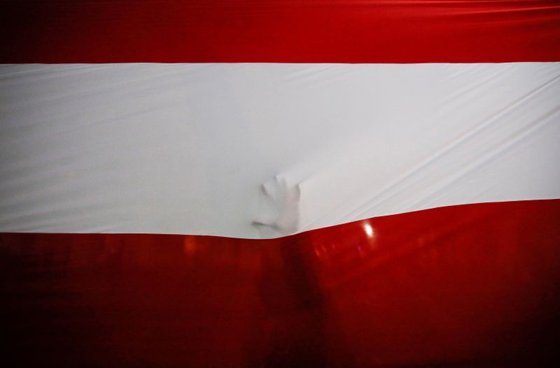 A person touches the national flag after Francisco Sagasti from