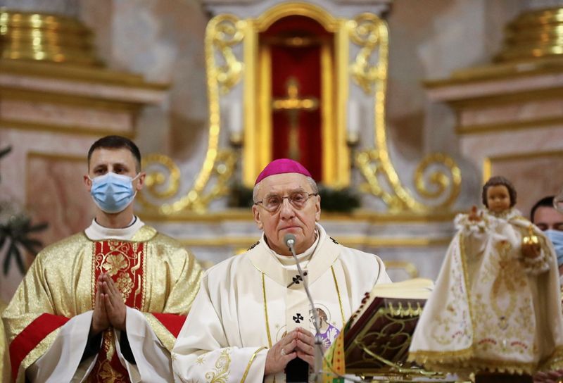 Archbishop Tadeusz Kondrusiewicz conducts a service on Christmas Eve in