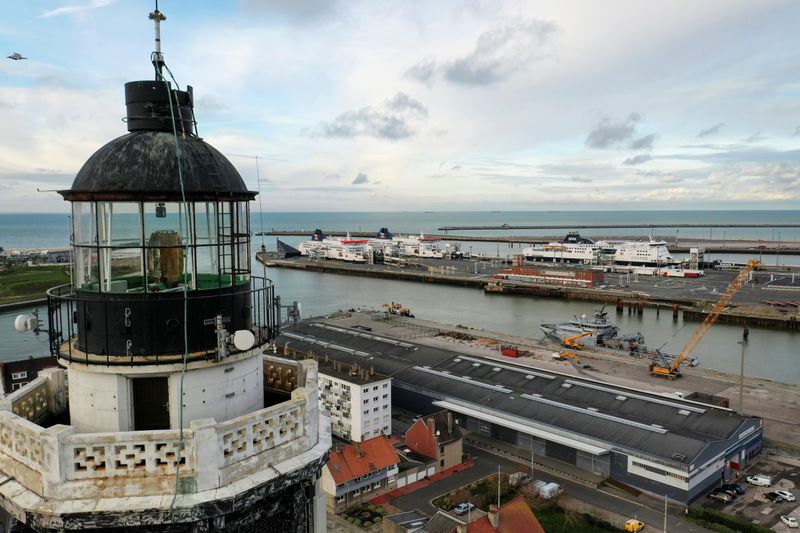 The ferry terminal is seen behind the top of lighthouse