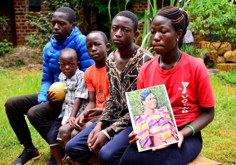 Kibenge sits with his children during a Reuters interview about