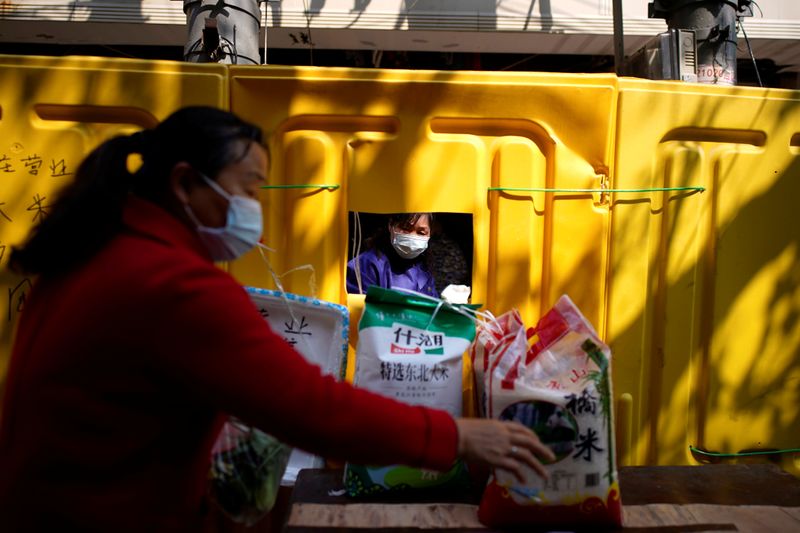 Resident wearing a face mask buys food from a grocery