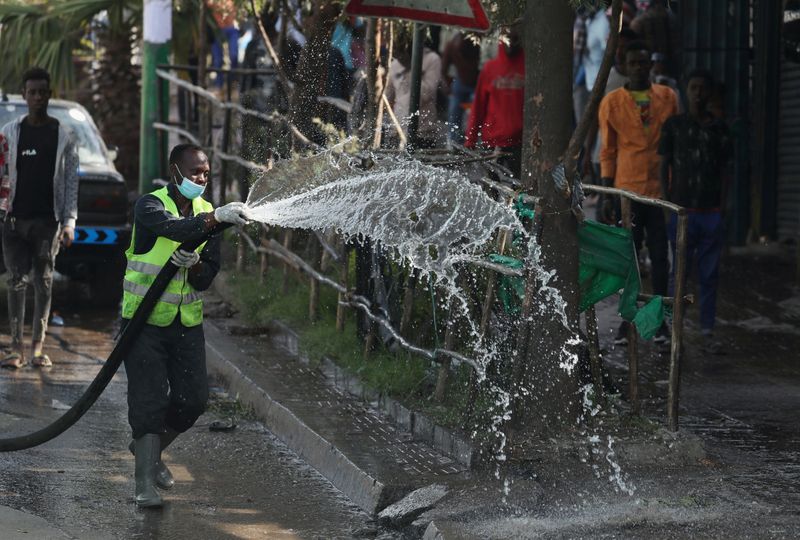 An Ethiopian health worker sprays disinfectant as part of measures