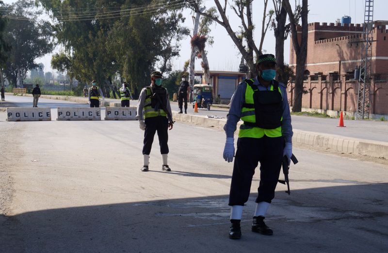 FILE PHOTO: Police officers stand guard at a blocked road