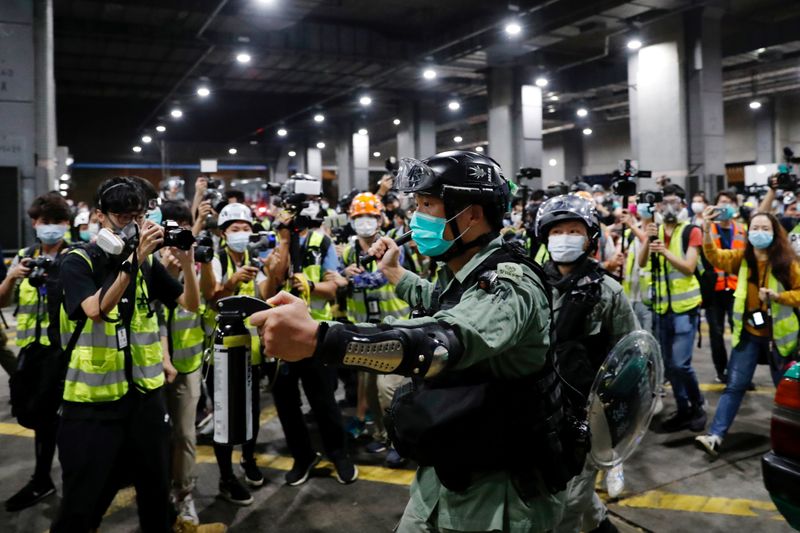 FILE PHOTO: A riot police holds a pepper spray as
