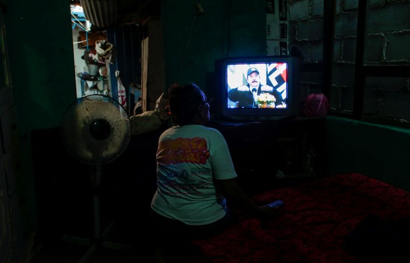 A supporter watches a telecast of Nicaraguan President Daniel Ortega