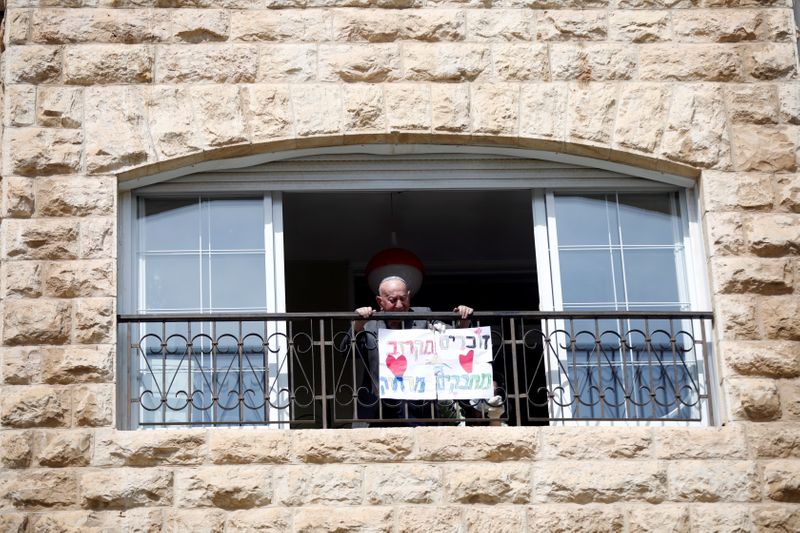 Elias Feinzilberg, a 102-year-old Holocaust survivor, stands at the window