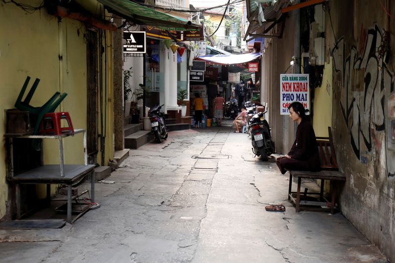 A zen practitioner sits on an empty street during the
