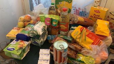 Food supplies donated to Brazilian migrants living in an overcrowded