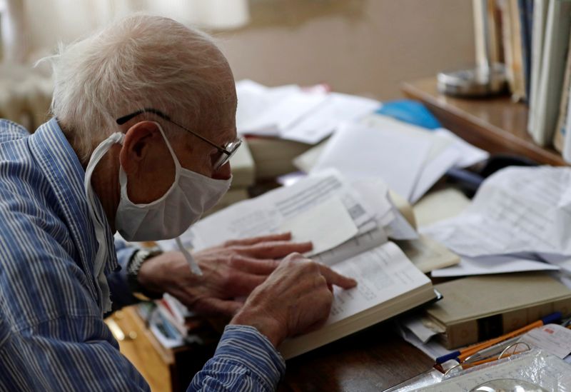 Petr Brandejsky, a 90-year-old Holocaust survivor, reads a book at