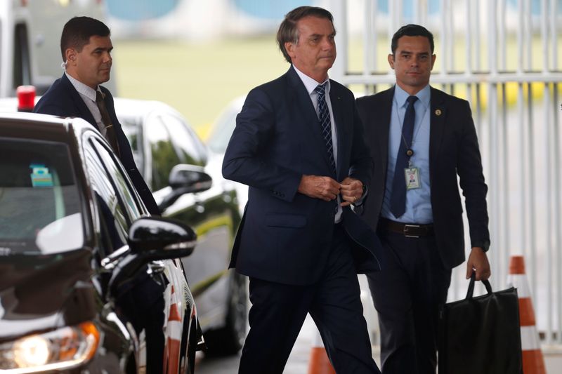 Brazil’s President Jair Bolsonaro walks as he leaves the Alvorada
