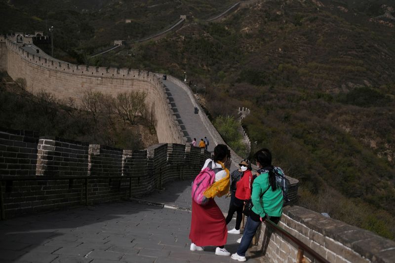 FILE PHOTO: Visitor poses for pictures at the Badaling section