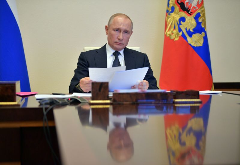 Russian President Vladimir Putin chairs a meeting via a video
