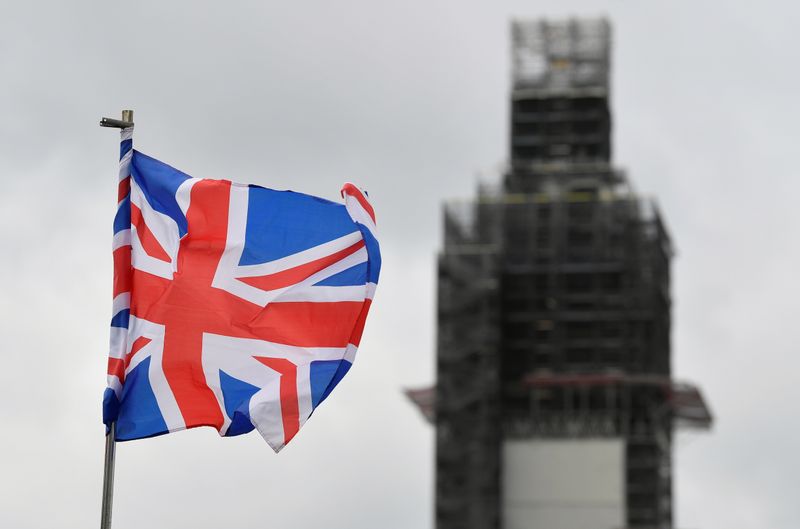 A Union Jack flag flutters as Big Ben clock tower