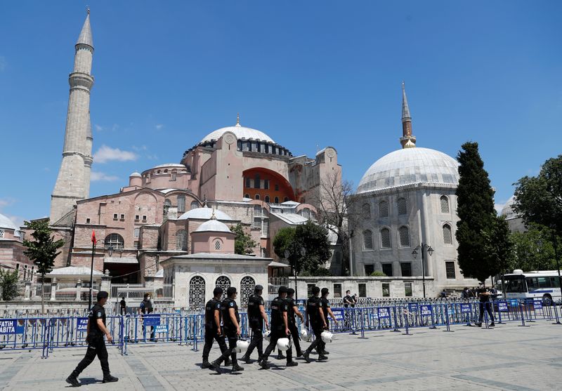 Police officers walk in front of Hagia Sophia, or Ayasofya-i