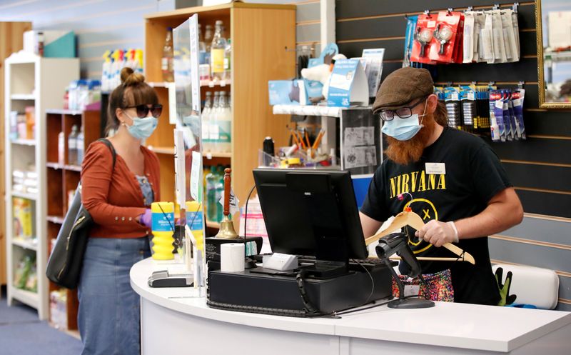 FILE PHOTO: An employee wearing a protective face mask serves