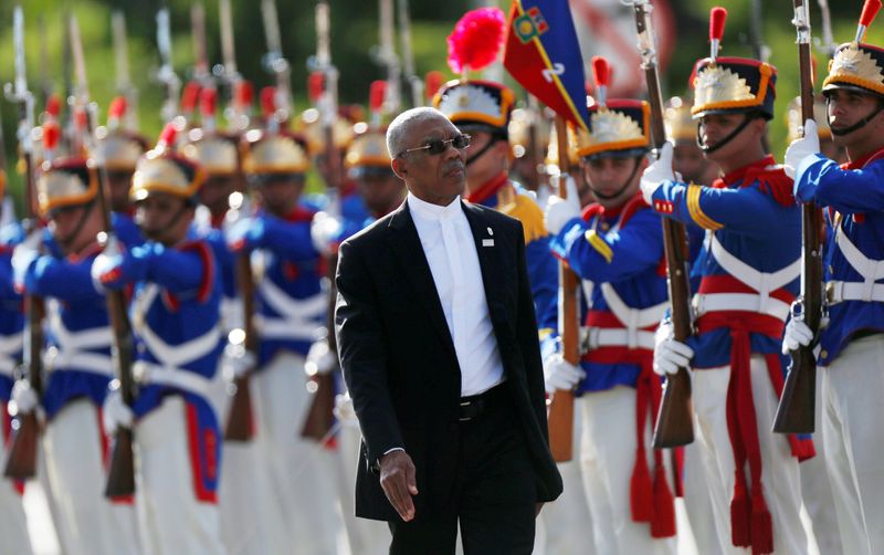 FILE PHOTO: Guyana’s President David Arthur Granger review an honour