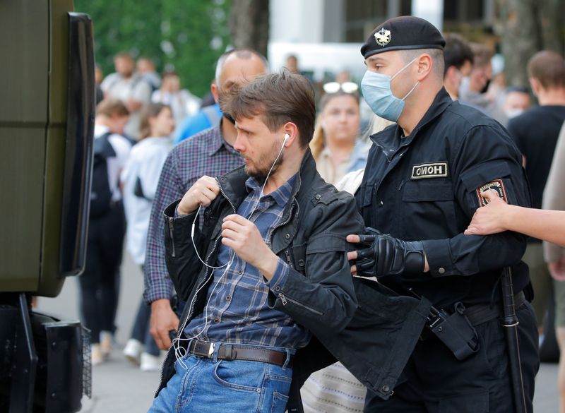 Law enforcement officers detain a man outside the Belarusian election