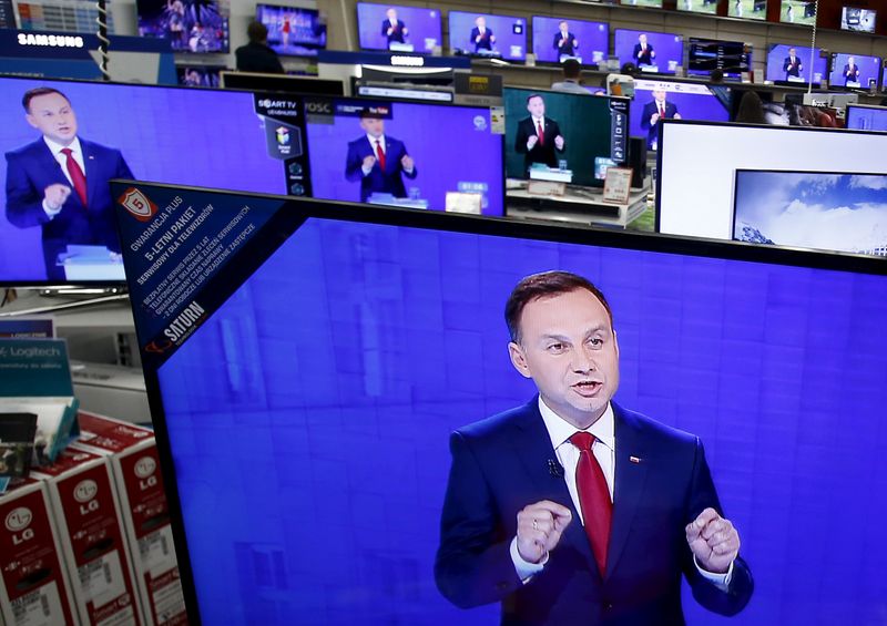 FILE PHOTO: Andrzej Duda is seen on television screens at