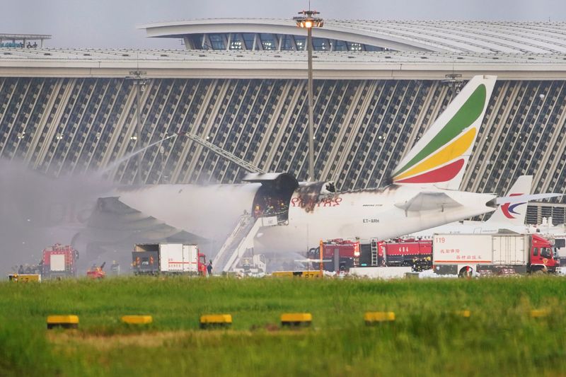 Firefighters work at the site where an Ethiopian Airlines cargo