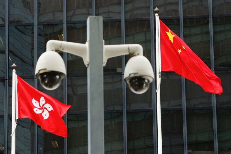 FILE PHOTO: Hong Kong and Chinese national flags are flown
