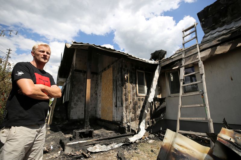 Ukrainian anti-corruption activist Vitaliy Shabunin stands next to his house,