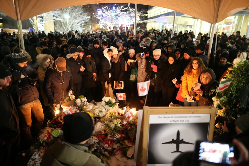 Mourners attend a memorial for the victims of a Ukrainian