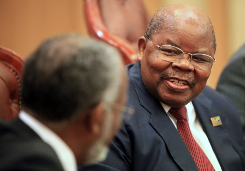 FILE PHOTO: Tanzania’s former President Mkapa speaks with Sudan’s Foreign