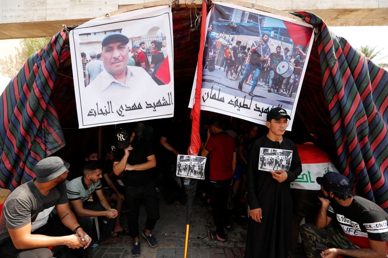 Iraqi demonstrators gather at a memorial for a protester, who