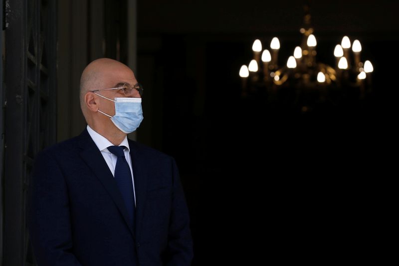 Greek Foreign Minister Nikos Dendias waits to welcome his Italian