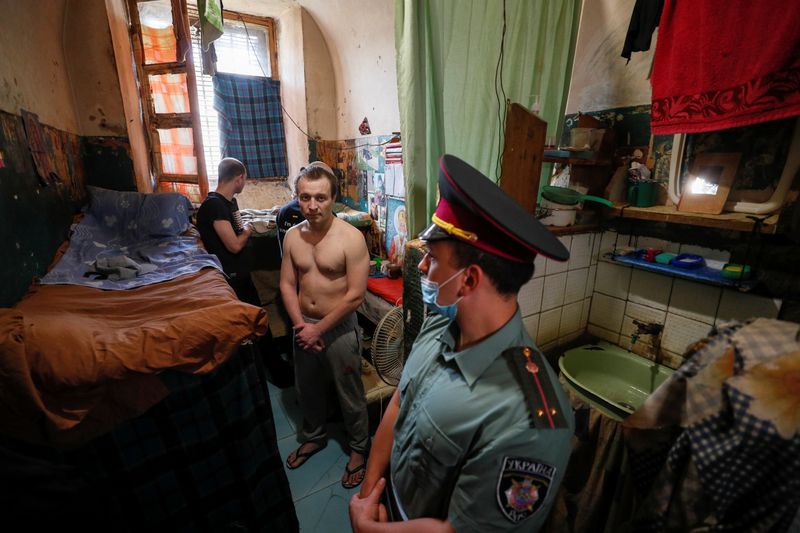 Detainees are seen in an old cell in a pre-trial