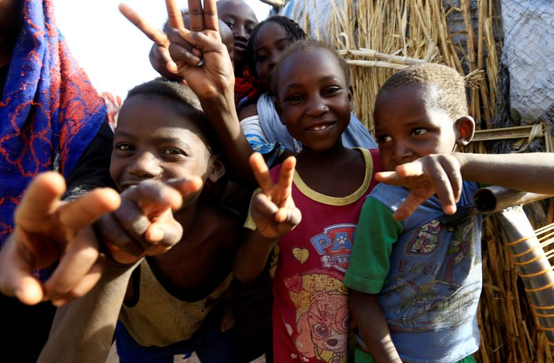 FILE PHOTO: Internally displaced Sudanese children gesture to the photographer