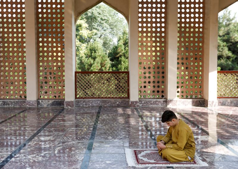 An Afghan boy prays during the Muslim festival of Eid