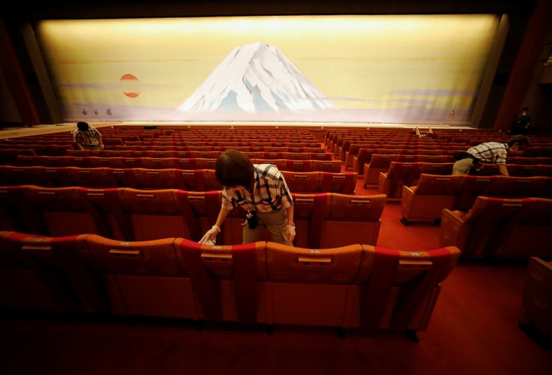 Workers disinfect seats at the Kabukiza Theatre amid the coronavirus