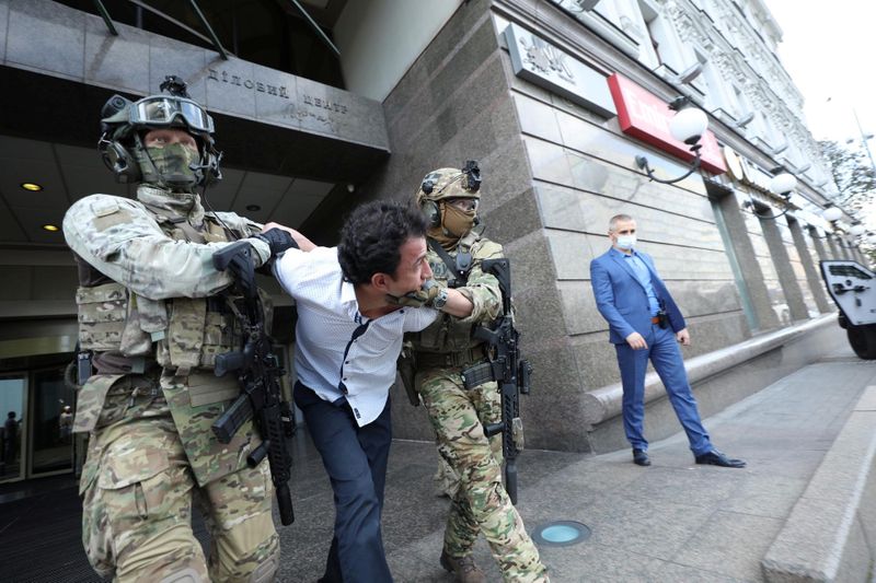 Members of the Security Service of Ukraine detain a man