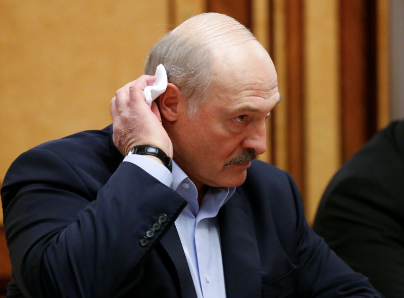 Belarusian President Alexander Lukashenko listens to Russian President Vladimir Putin