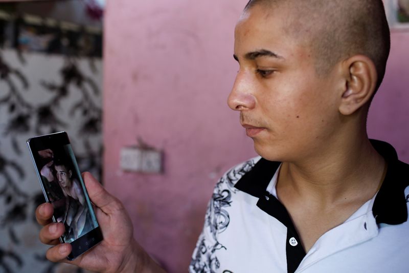Iraqi teenager Hamid Saeed shows a video that circulated on
