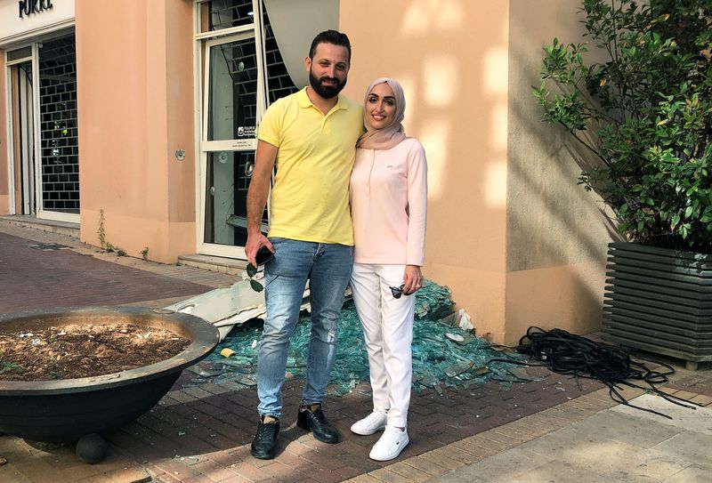 Bride Israa Seblani poses for a picture with her husband