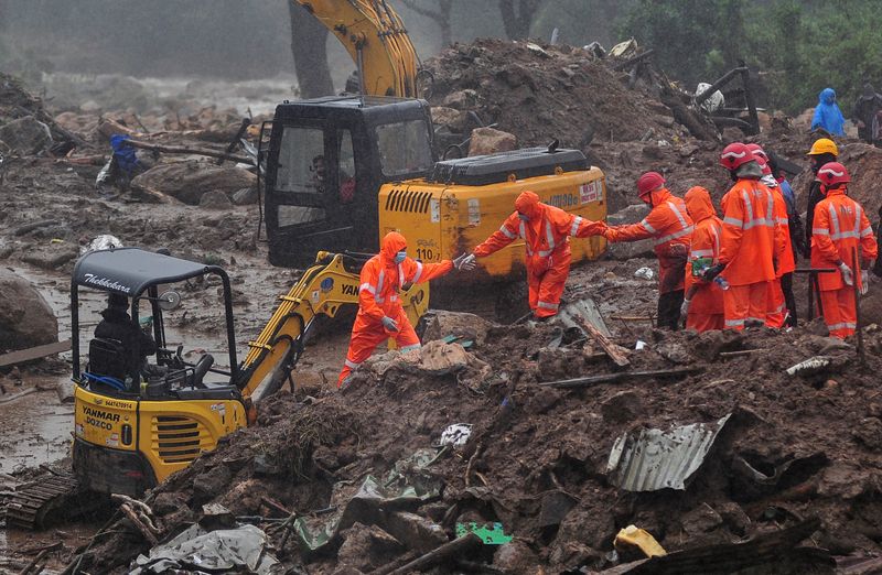 Rescue workers look for survivors at the site of a