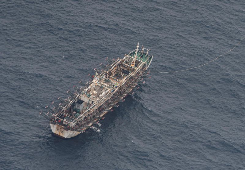 A fishing boat is seen from an aircraft of the
