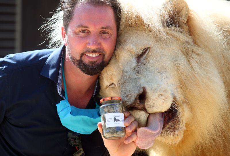 Lion tamer Lacey poses with Lion King Tonga and a