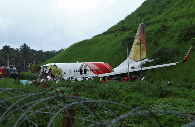 Officials inspect the site where a passenger plane crashed when